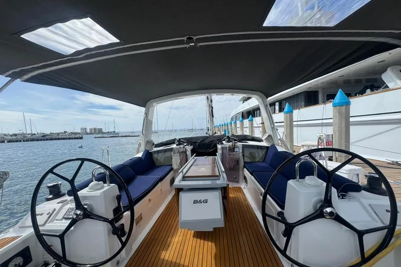 Bambino Yacht Photos Pics 2019 Beneteau Oceanis 41.1 yacht cockpit with dual steering wheels and teak flooring at marina.