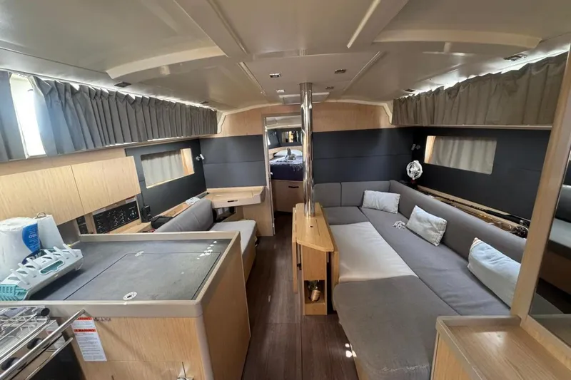 Bambino Yacht Photos Pics Interior of 2019 Beneteau Oceanis 41.1 yacht, featuring modern seating and wooden finishes.