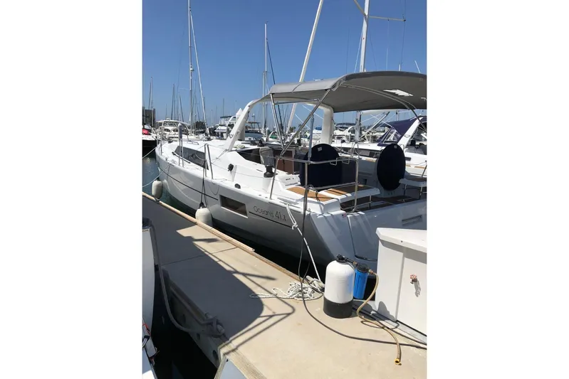 Bambino Yacht Photos Pics 2019 Beneteau Oceanis 41.1 yacht docked at marina under clear blue sky.