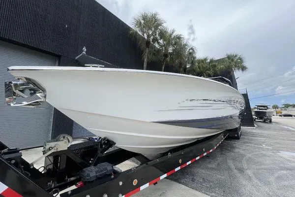  Yacht Photos Pics 2019 Nor-Tech 450 Sport Center Console boat on trailer, parked near palm trees.