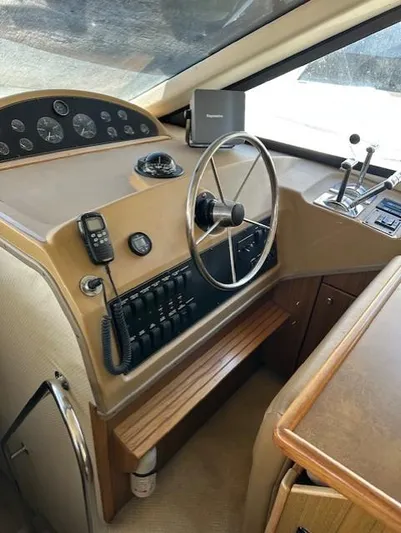  Yacht Photos Pics 2002 Bayliner 3988 Command Bridge Motoryacht helm with steering wheel and control panel.