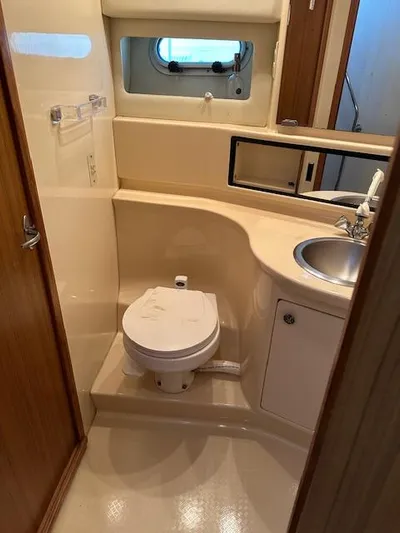  Yacht Photos Pics 2002 Bayliner 3988 Command Bridge Motoryacht bathroom with toilet, sink, and window.