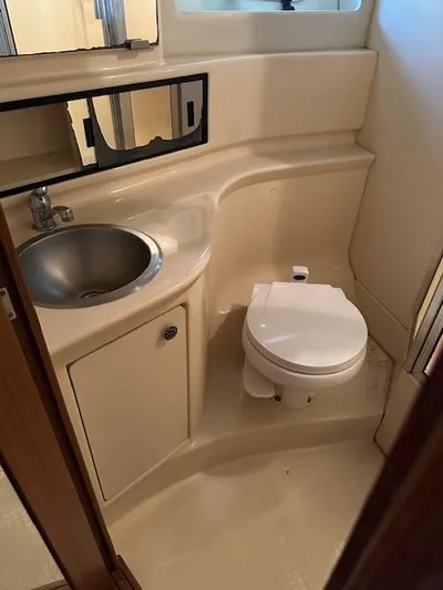  Yacht Photos Pics 2002 Bayliner 3988 Command Bridge Motoryacht bathroom with sink, toilet, and mirror.