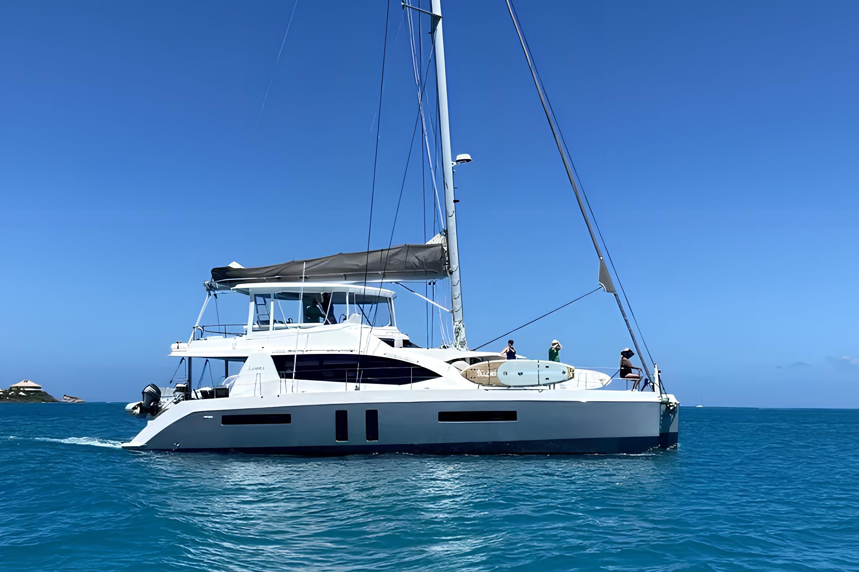 Luxurious 2014 Leopard 58 yacht sailing on clear blue ocean waters.
