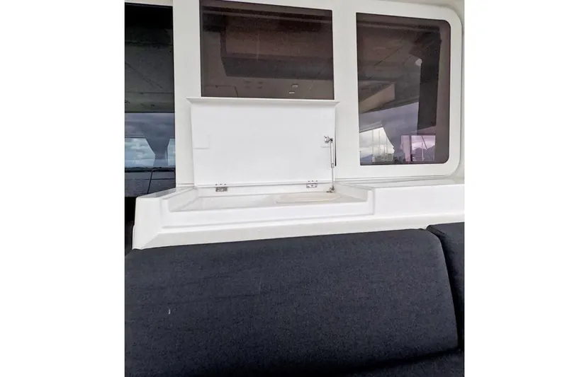 Rhapsody Yacht Photos Pics Interior view of 2021 Lagoon 52 F yacht with seating and window.