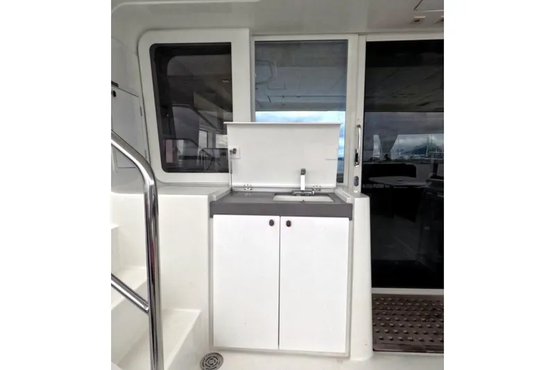 Rhapsody Yacht Photos Pics Outdoor kitchenette on 2021 Lagoon 52 F yacht with sink and storage.