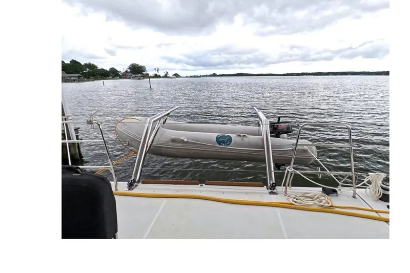 Rhapsody Yacht Photos Pics Lagoon 52 F yacht with dinghy on calm waters, 2021 model.