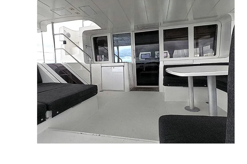 Rhapsody Yacht Photos Pics Interior of 2021 Lagoon 52 F yacht, featuring seating and a table.