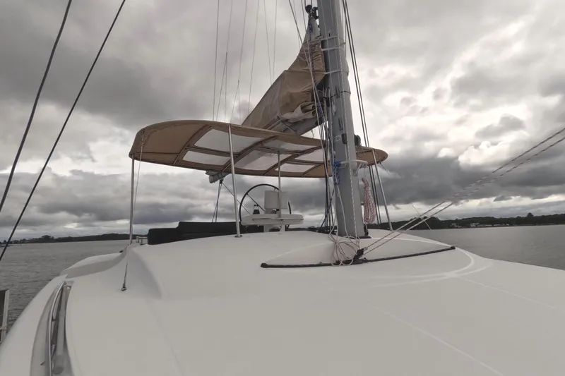 Rhapsody Yacht Photos Pics Sailing catamaran Lagoon 51, 2021 model, on a cloudy day at sea.