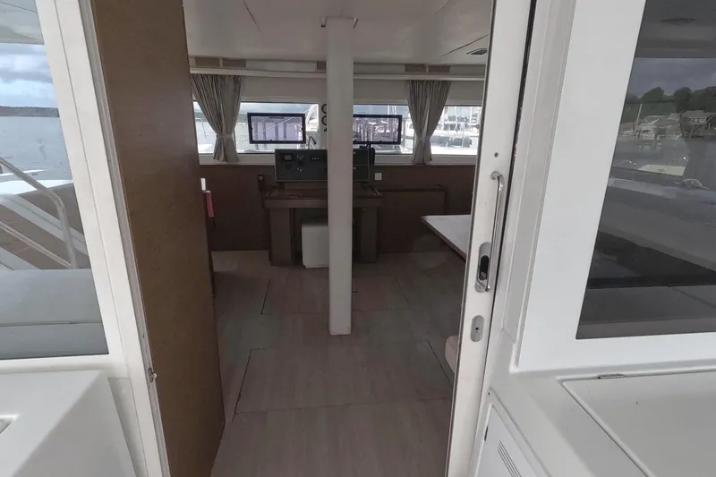Rhapsody Yacht Photos Pics Interior view of 2021 Lagoon 51 yacht, featuring navigation area and windows.