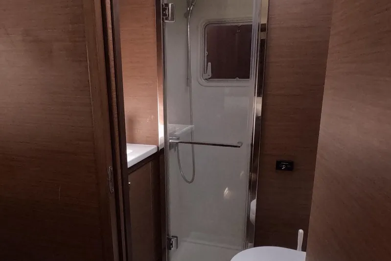 Rhapsody Yacht Photos Pics Bathroom interior of 2021 Lagoon 52 F yacht with shower and toilet.