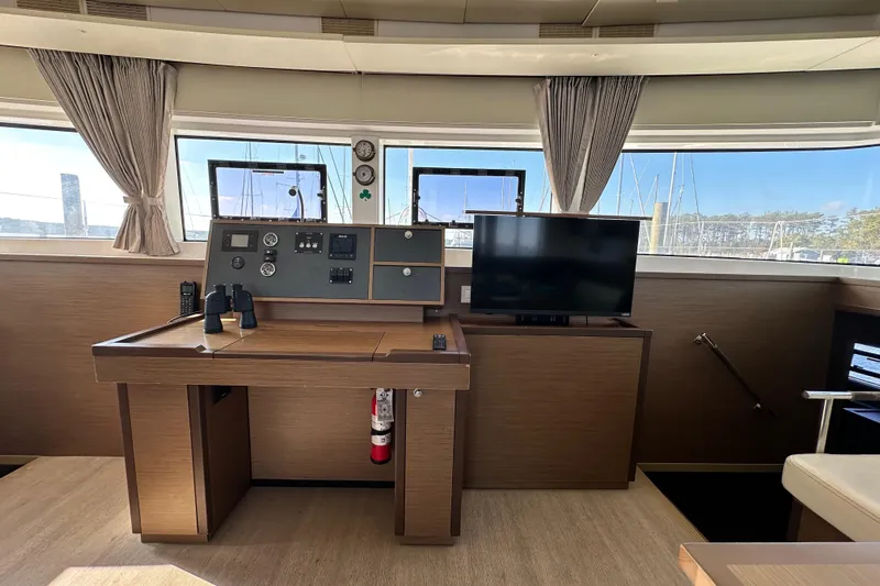Rhapsody Yacht Photos Pics Luxurious interior of 2021 Lagoon 52 F yacht with navigation station and TV.