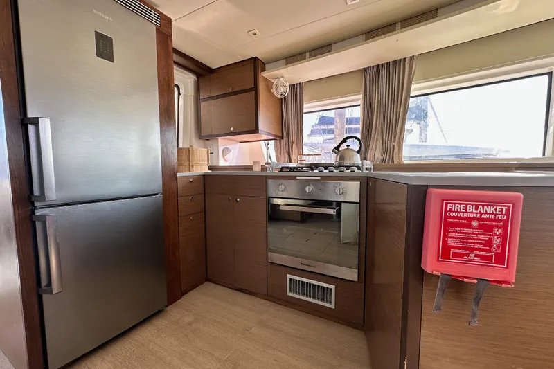 Rhapsody Yacht Photos Pics Modern kitchen interior of 2021 Lagoon 52 F yacht with stainless steel appliances.