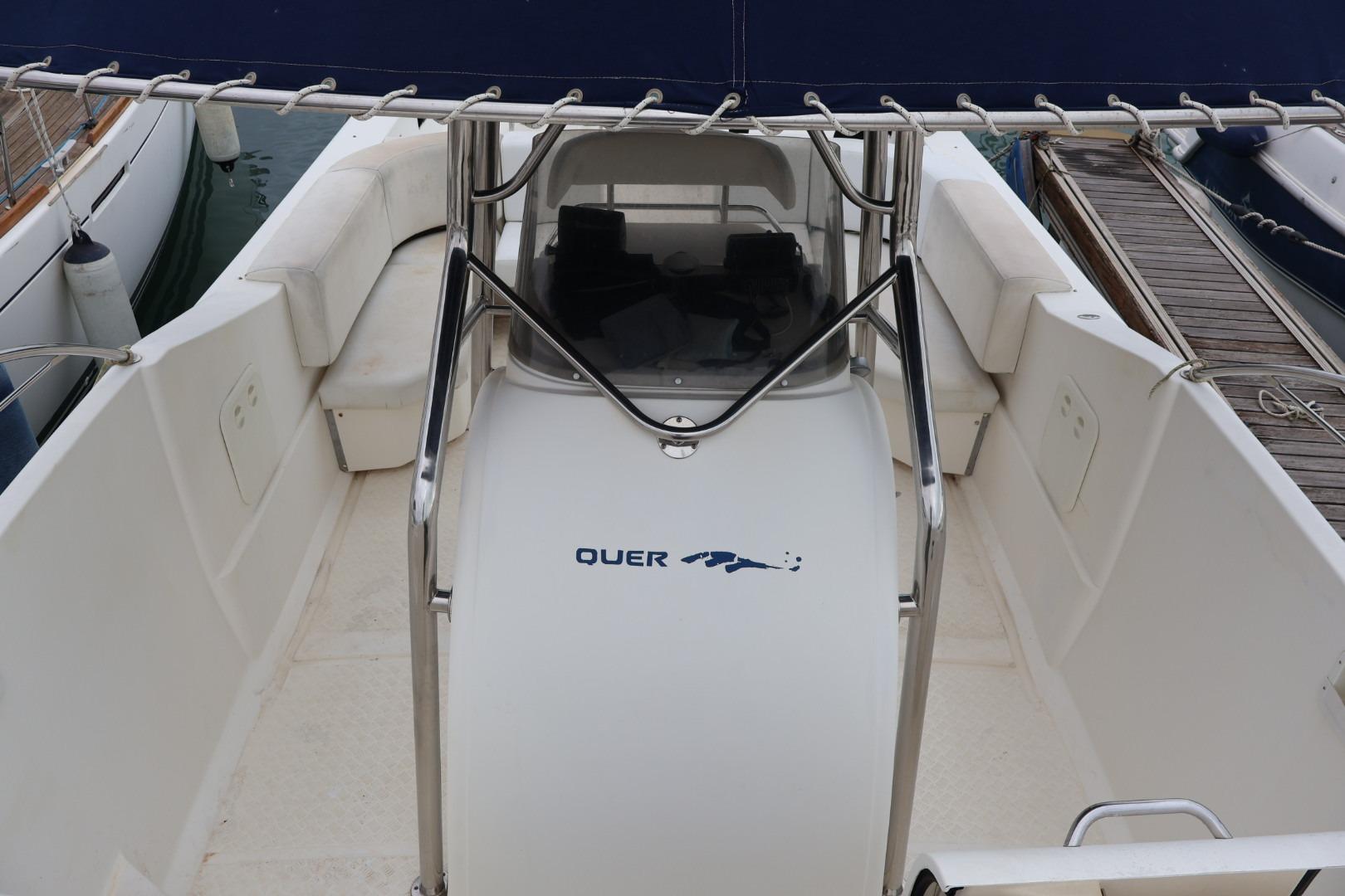 2004 Quer 32 Cuddy boat interior with seating and console, docked at marina.