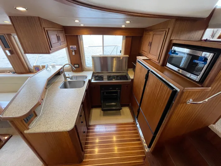 Pacific Rose Yacht Photos Pics Interior of 2009 American Tug 49 Limited, featuring a modern kitchen with wood cabinetry.