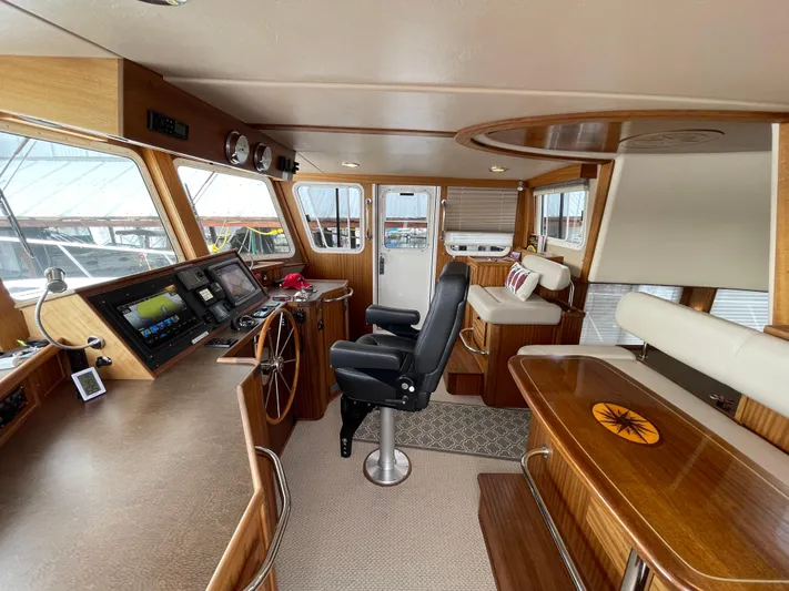 Pacific Rose Yacht Photos Pics Interior of 2009 American Tug 49 Limited, featuring helm, seating, and navigation equipment.