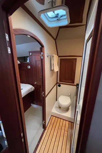 Pacific Rose Yacht Photos Pics 2009 American Tug 49 Limited bathroom with wooden accents and skylight.