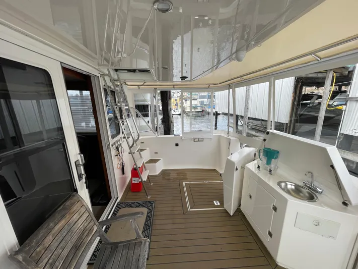 Pacific Rose Yacht Photos Pics Spacious deck of 2009 American Tug 49 Limited with seating and sink.