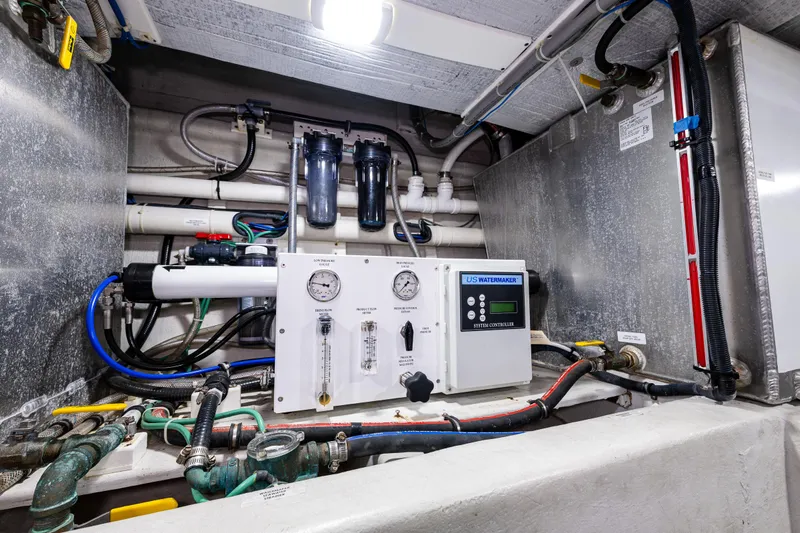 Pacific Rose Yacht Photos Pics Engine room of 2009 American Tug 49 Limited with control panel and piping.