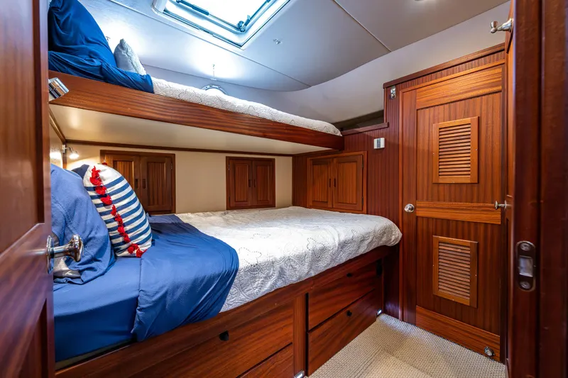 Pacific Rose Yacht Photos Pics Cozy cabin with wooden bunk beds in a 2009 American Tug 49 Limited yacht.