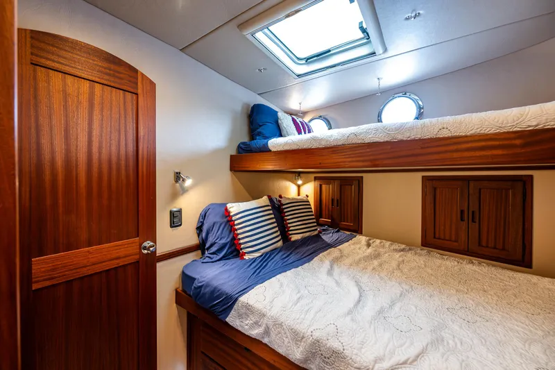 Pacific Rose Yacht Photos Pics Cozy cabin interior of 2009 American Tug 49 Limited with wooden finishes and skylight.