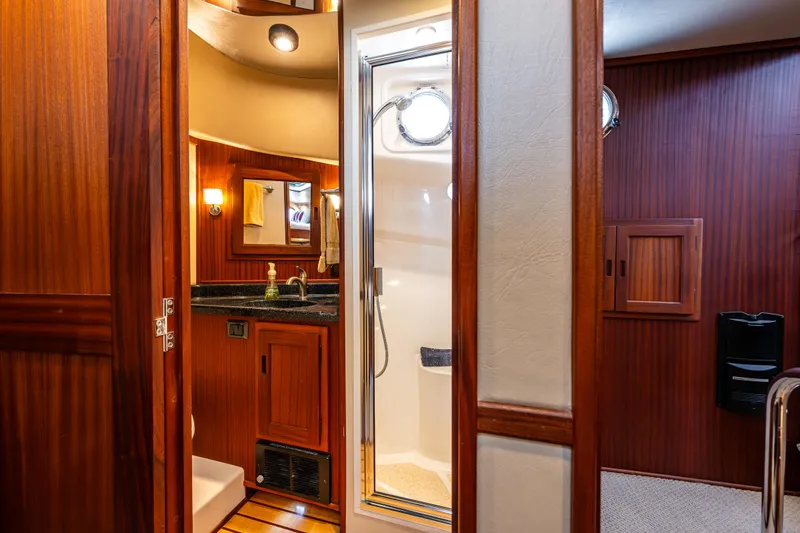 Pacific Rose Yacht Photos Pics Luxurious bathroom interior of 2009 American Tug 49 Limited yacht with wood accents and shower.