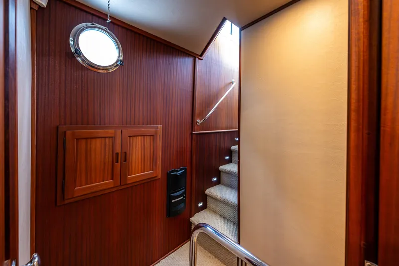 Pacific Rose Yacht Photos Pics Interior of 2009 American Tug 49 Limited, featuring wooden paneling and carpeted stairs.