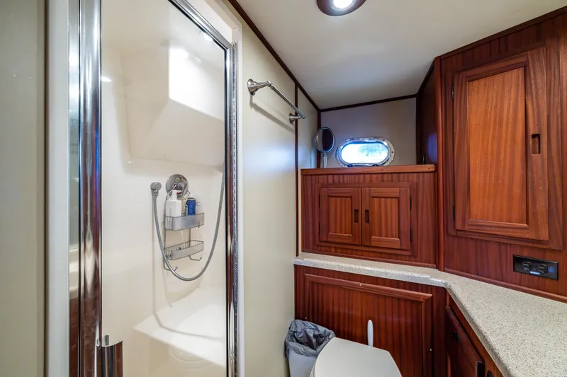 Pacific Rose Yacht Photos Pics Bathroom interior of 2009 American Tug 49 Limited with wood cabinetry and shower.