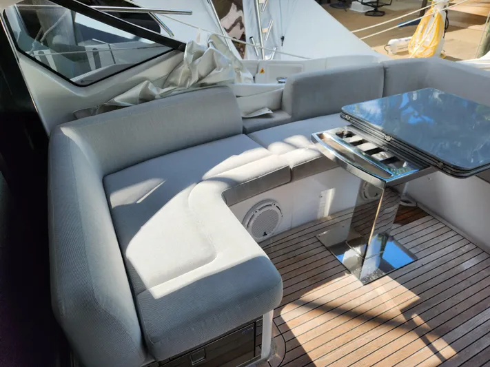 Pri Sea Yacht Photos Pics Luxurious seating area on 2019 Azimut S6 yacht with sleek table and wooden deck.