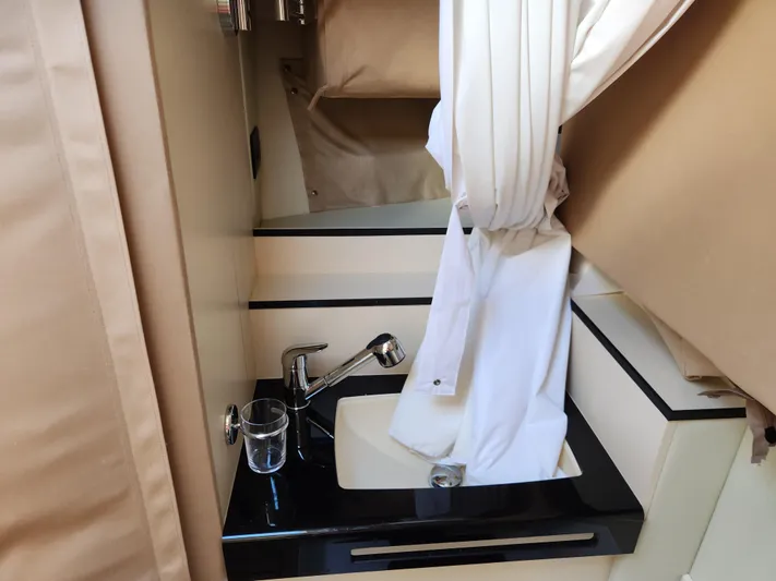 Pri Sea Yacht Photos Pics 2019 Azimut S6 yacht bathroom sink with modern fixtures and white curtain.
