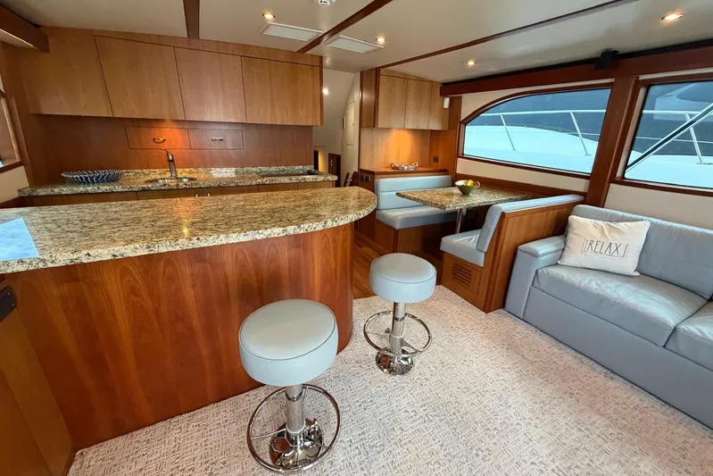  Yacht Photos Pics Luxurious 2011 Hatteras GT60 yacht interior with modern kitchen and cozy seating area.