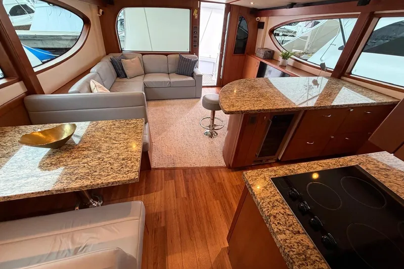  Yacht Photos Pics Luxurious interior of 2011 Hatteras GT60 yacht with granite countertops and plush seating.