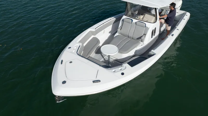  Yacht Photos Pics 2018 Belzona 325 Center Console boat on water, featuring sleek design and spacious seating.