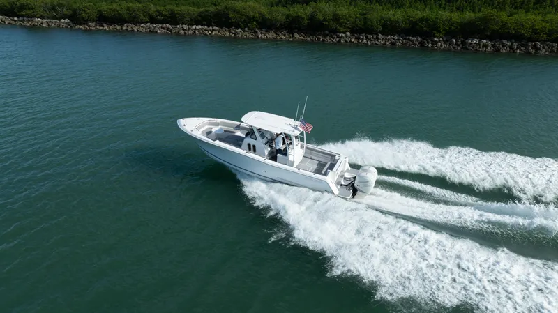  Yacht Photos Pics 2018 Belzona 325 Center Console boat cruising on a calm waterway.
