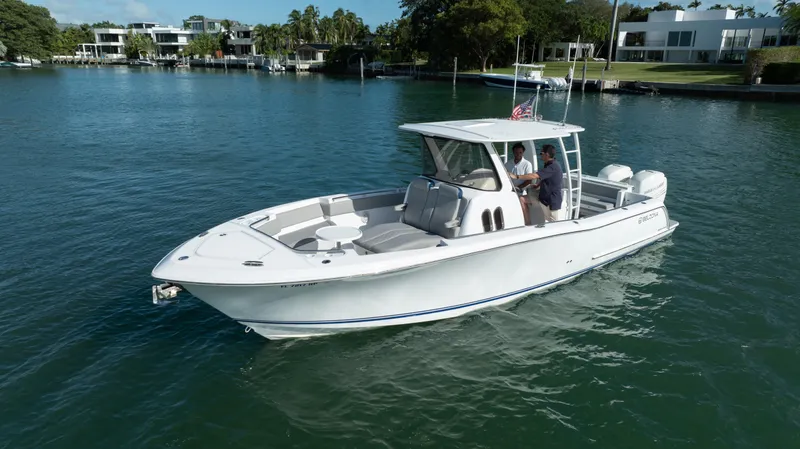  Yacht Photos Pics 2018 Belzona 325 Center Console boat cruising on a serene waterway.
