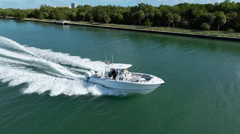  Yacht Photos Pics 2018 Belzona 325 Center Console boat cruising on a scenic waterway.