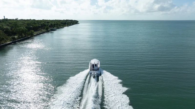  Yacht Photos Pics Belzona 325 Center Console boat cruising on open water, 2018 model.