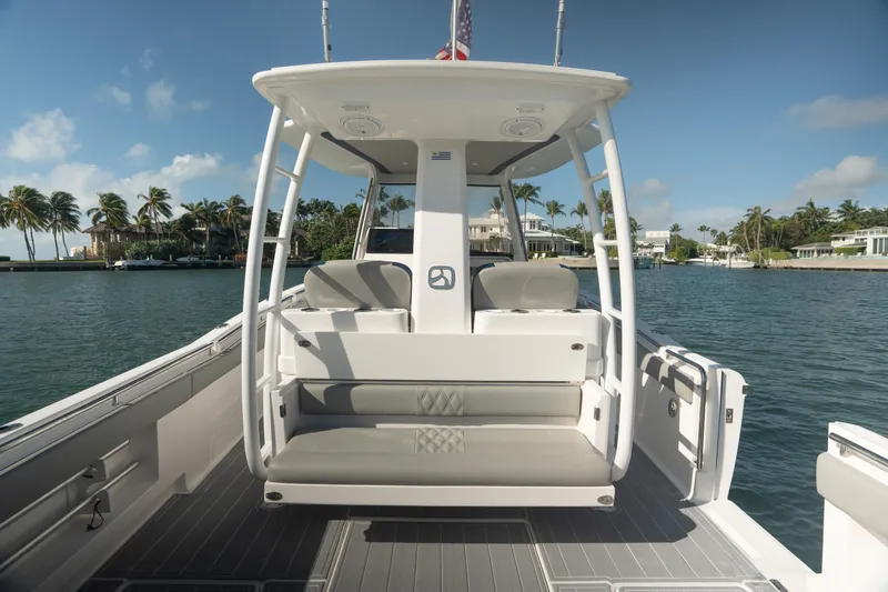  Yacht Photos Pics 2018 Belzona 325 Center Console boat on calm water, featuring spacious seating and sleek design.