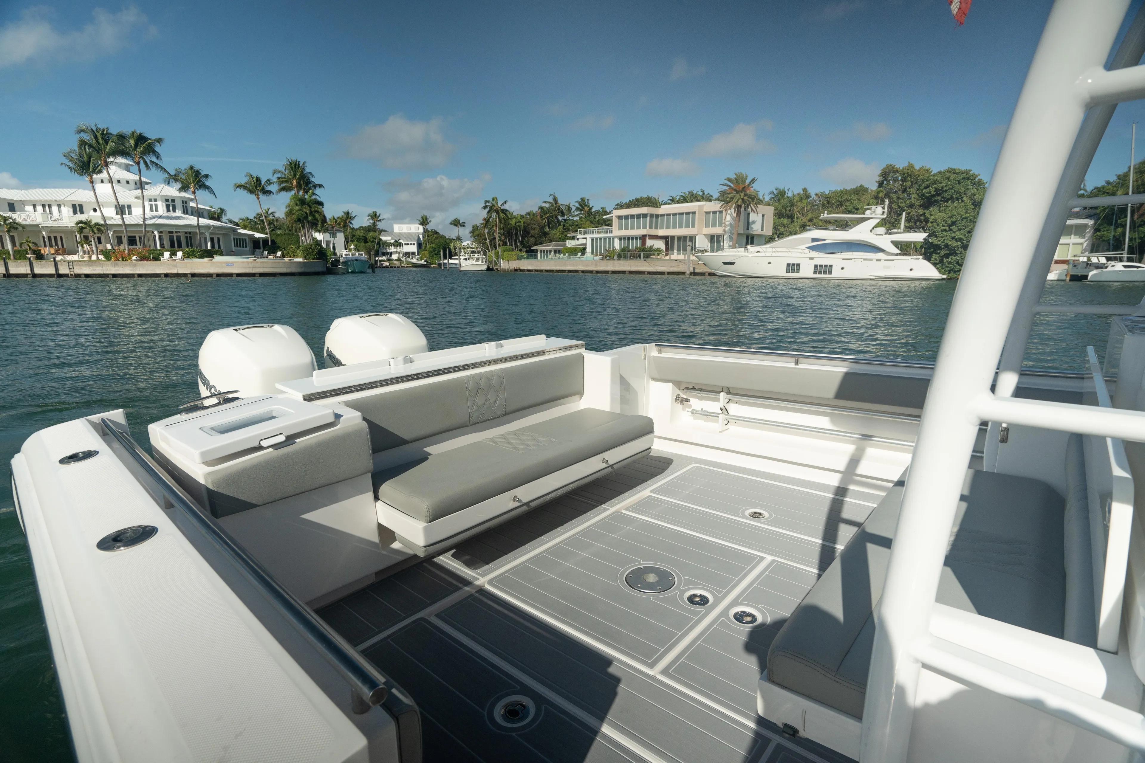  Yacht Photos Pics 2018 Belzona 325 Center Console boat on a sunny waterfront with luxury homes.