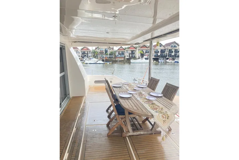  Yacht Photos Pics Luxurious 2018 Leopard 58 yacht deck with elegant dining setup overlooking marina.