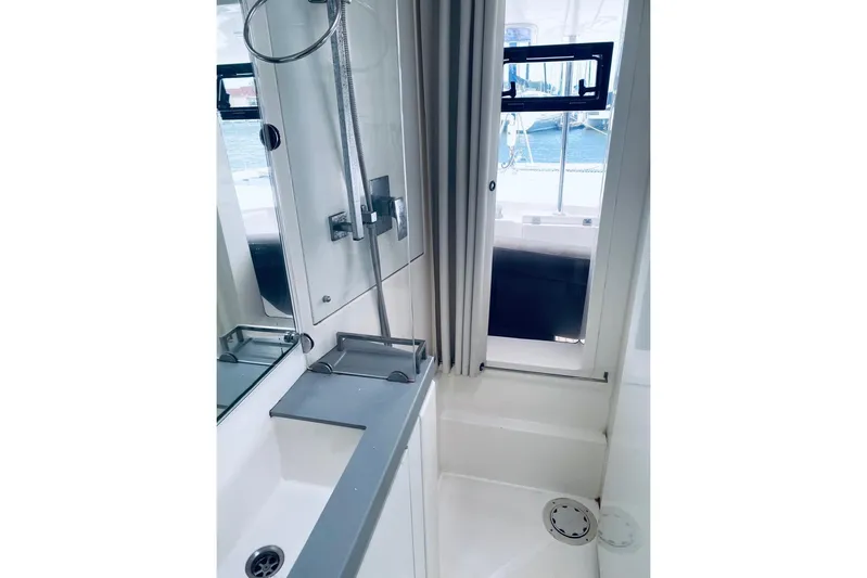  Yacht Photos Pics Modern bathroom interior on 2018 Leopard 58 yacht with shower and window view.