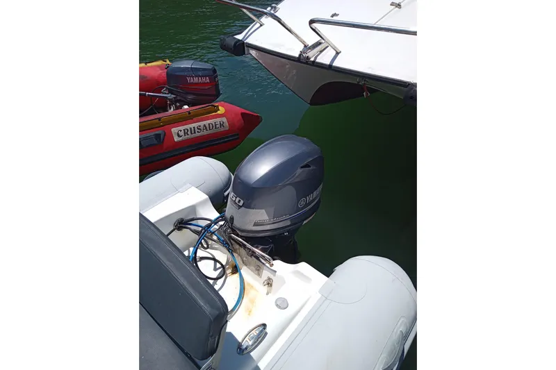  Yacht Photos Pics Yamaha outboard motor on a 2018 Leopard 58 boat, with a red inflatable boat nearby.
