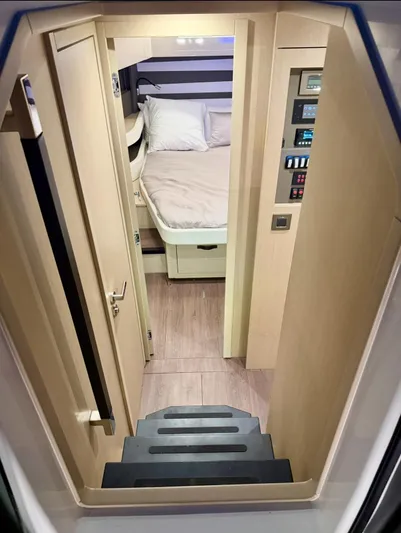  Yacht Photos Pics 2024 Jeanneau DB/43 OB cabin interior with bed and control panel.