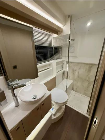  Yacht Photos Pics Luxurious bathroom in 2024 Jeanneau DB/43 OB yacht with modern fixtures and elegant design.