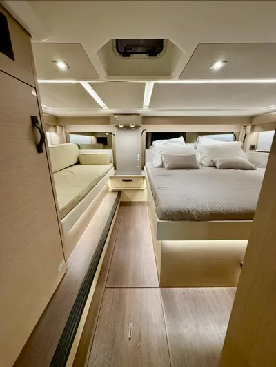  Yacht Photos Pics 2024 Jeanneau DB/43 OB cabin interior with modern design and cozy bedding.
