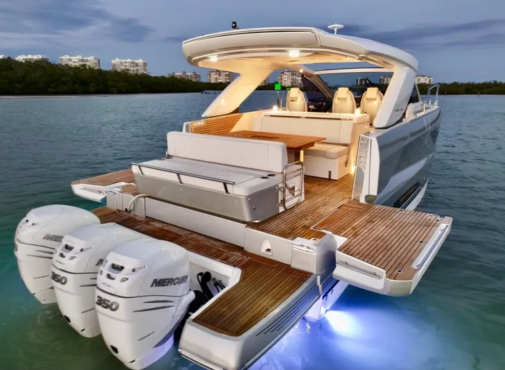  Yacht Photos Pics 2024 Jeanneau DB/43 OB luxury boat with triple Mercury engines, illuminated deck, and sleek design.