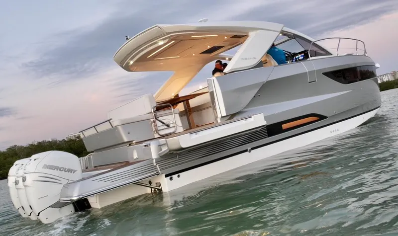  Yacht Photos Pics 2024 Jeanneau DB/43 OB yacht on water at sunset, showcasing sleek design and modern features.