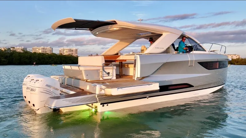  Yacht Photos Pics 2024 Jeanneau DB/43 OB yacht cruising on serene waters at sunset.