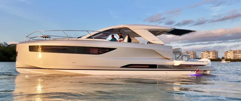  Yacht Photos Pics 2024 Jeanneau DB/43 OB yacht cruising on calm waters at sunset.