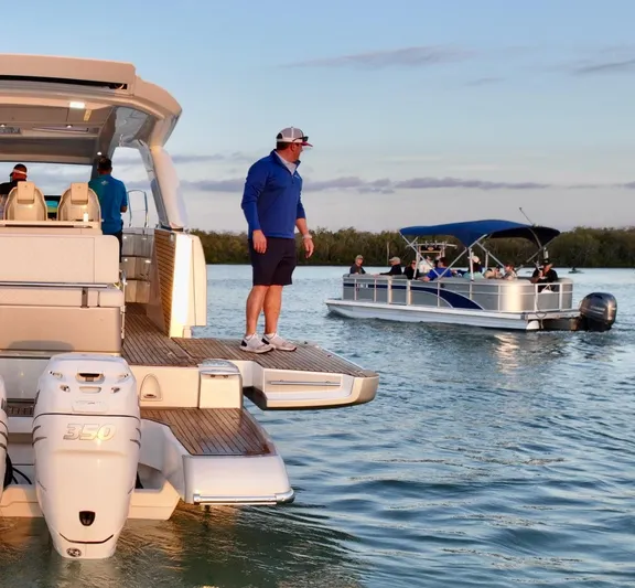  Yacht Photos Pics 2024 Jeanneau DB/43 OB yacht on water, with people enjoying a sunny day.